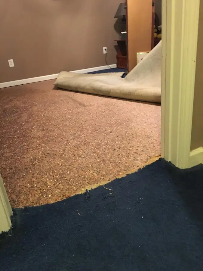 Carpet pad removal revealing water damage during Water Mitigation Services in Tyler